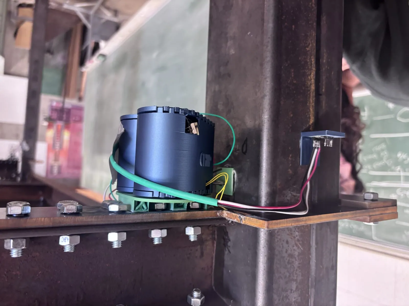 A CHIIP unit clamped to a steel beam-column joint.